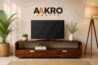 Premium solid wood media unit in a modern living room featuring the AAKRO Crafts logo, elegant wooden TV console, indoor plants, warm lighting, and contemporary home décor.